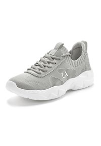 Light gray mesh athletic shoe with a textured surface, adjustable laces, and a white, flexible rubber sole. Features logo on the side.