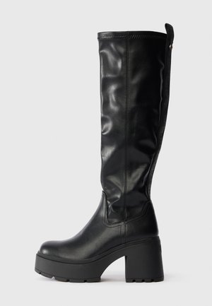 Knee-high black faux leather boots with a chunky platform heel, smooth texture, and a side zipper for easy wear.