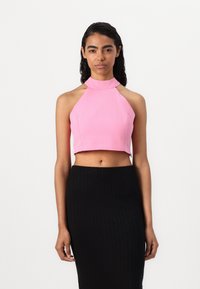 Rozā īsā halter top ar augstu kakla izgriezumu un bez piedurknēm, kombinēts ar melnu ribota svārku. Gluda tekstūra, pieguļoša siluets.