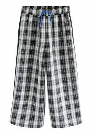 Pantalones cortos a cuadros en blanco y negro con cinturilla elástica, cordón azul y bolsillos laterales. Fabricados en un tejido de algodón ligero.