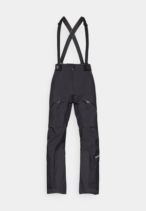 Czarne spodnie narciarskie z regulowanymi krzyżowymi ramiączkami, zamkami błyskawicznymi na nogawkach oraz wzmocnieniami na kolanach. Wykonane z trwałego, wodoodpornego materiału.