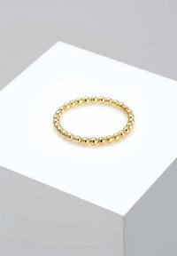 Gouden ring met kralen in een glad, afgerond ontwerp. Voorzien van gelijkmatig verdeelde, gepolijste bolvormige kralen, die een doorlopende cirkelvorm creëren.