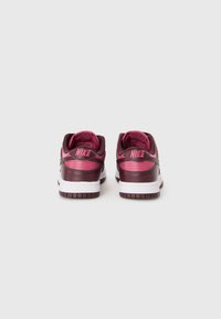 Nike sneakers featuring a maroon leather upper with pink accents, white midsole, and a textured rubber outsole, designed for comfort and stability.
