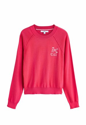 Hanorac roz din material moale. Prezintă mâneci raglan și tiv striat. Design mic alb brodat "mi-ai câștigat inima" pe piept.