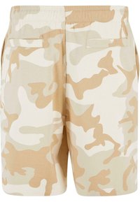 Beige camouflage shorts with an elastic waistband, two back pockets, and a soft, textured fabric. Features a muted color pattern.