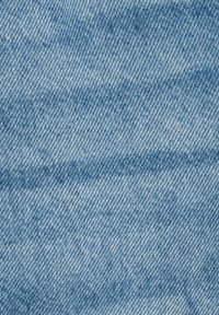 Tessuto denim di colore azzurro chiaro, con un motivo a spina di pesce, caratterizzato da tonalità variabili e una superficie leggermente texturizzata.