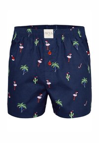 Boxers de couleur bleu marine avec une taille élastique, ornés d'un motif répétitif de flamants roses, de palmiers, de cactus et d'icônes de Noël.
