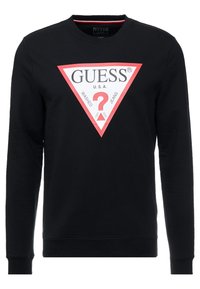 Felpa nera con maniche lunghe, collezione a girocollo, caratterizzata da un grande logo triangolare bianco e rosso che include la scritta "GUESS" e un punto interrogativo.