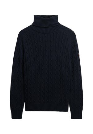 Pull col roulé en maille torsadée bleu marine avec des poignets, un ourlet et un col côtelés, présentant une petite patch sur la manche gauche.