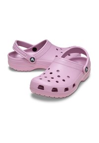 Pink rubber clogs featuring perforated design for ventilation, a back strap for support, and a textured sole for grip.