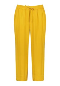 Żółte, lekkie spodnie z elastycznym pasem i sznurkiem do regulacji. Proste nogawki o gładkiej strukturze i bez widocznych kieszeni.