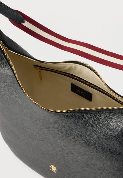 Μαύρη δερμάτινη τσάντα χειρός με λείο, υφασματώδες φινίρισμα. Διαθέτει χρυστό φερμουάρ, εσωτερική επένδυση σε μπεζ και ριγέ λουράκι ώμου σε κόκκινο και κρεμ.