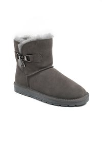 Bota de ante gris con un suave forro de piel sintética gris, detalle de hebilla decorativa y una suela de goma plana. Cuenta con un diseño de puntera redondeada.