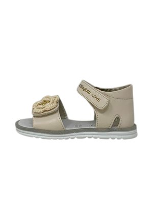 Sandali in pelle beige con cinturino a strappo, accentuati da un fiore testurizzato e suola in gomma bianca. Design confortevole con dettagli a taglio.
