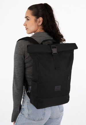 Black roll-top backpack made of durable fabric, featuring a front zip pocket and adjustable straps, showcased against a white background.