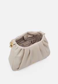 Beige pleated handbag with a soft fabric exterior, gold hardware, and an interior zipper pocket. Bag opens at the top for easy access.