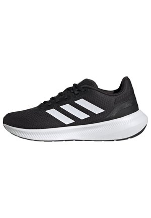 Chaussure de course Adidas noire avec trois bandes blanches sur le côté et une semelle épaisse blanche, vue de l'extérieur.
