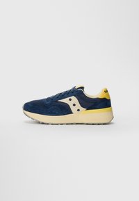 Sneaker blu navy realizzato in suede e mesh, con dettagli beige, un tallone giallo e una suola di crema texturizzata.