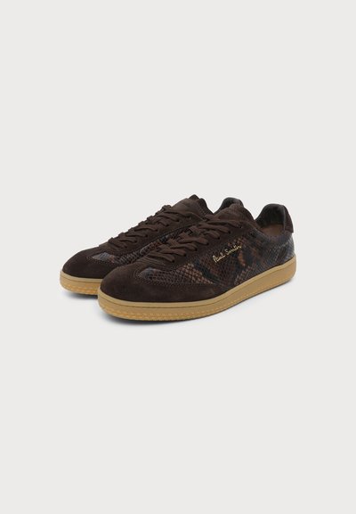 Baskets basses marron foncé en cuir texturé et daim, semelles en caoutchouc, lacets et logo doré "Paul Smith" sur le côté.