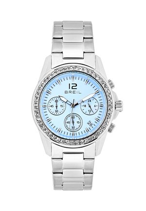 Sølv metalur ur med en lyseblå urskive, krystal dekorationer på bezel, tre undermeter og sorte timemarkører.