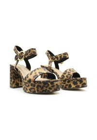 Sandalias de plataforma con estampado de leopardo, puntera abierta, tacón ancho, correas de tobillo ajustables y adornos circulares en tono dorado.