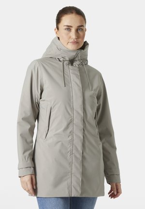 Light gray waterproof jacket with a high collar, adjustable drawstrings, and side pockets. Smooth texture and relaxed fit design.