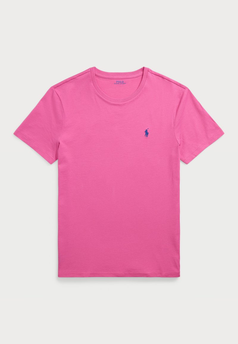 Ružičasta pamučna majica kratkih rukava s okruglim izrezom. Ima mali plavi logo na lijevoj strani prsnog koša. Glatka tekstura i klasičan kroj.