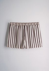 Brown and beige vertical striped elastic waistband shorts on a plain light gray background.