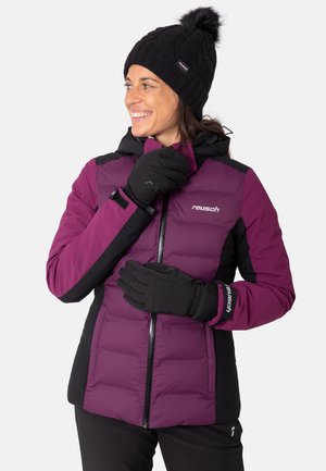 Purple and black insulated jacket with a hood, zip closure, and stitched panels. Black gloves and knit cap with pom-pom detail.