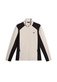 Giacca zip-up beige chiaro con pannelli laterali neri, colletto alto, maniche lunghe e logo sul petto. Tessuto liscio e leggero.