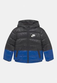 Czarna i niebieska ocieplana kurtka z kapturem, z poziomymi przeszyciami, zapięciem na zamek z przodu oraz białym logo Nike na klatce piersiowej.