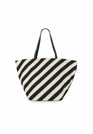Canvas handväska med svarta och beige diagonala ränder, med två svarta handtag och en rymlig, vinklad design.