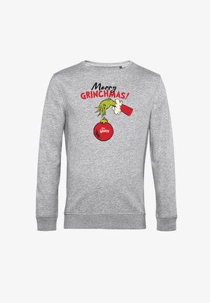 Szara bluza z kapturem z graficznym nadrukiem przedstawiającym zieloną dłoń, czerwoną rękę i czerwoną ozdobę choinkową, z napisem "Wesołego Grinchmas!" powyżej.