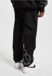 Rocawear Tracksuit bottoms - black