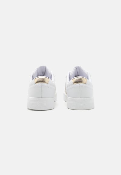 Vita sneakers med en slät lädertextur, med metalliska guldaccenter på hälen. Platt gummisula och vadderad krage för komfort.