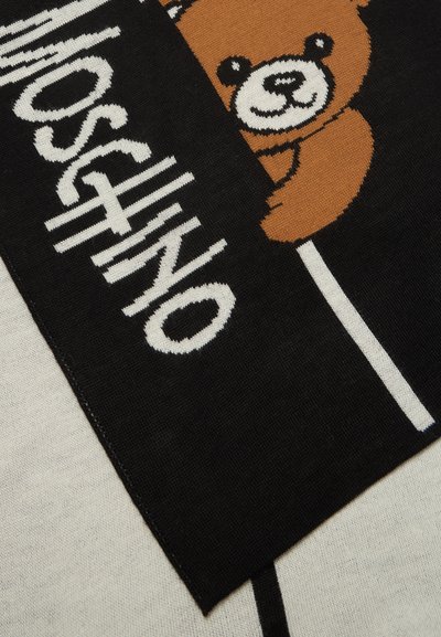Tissu tricot noir avec un ours en peluche marron tenant une sucette blanche et un texte blanc indiquant "Moschino."