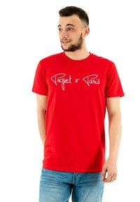 Red cotton t-shirt featuring white script text "Project x Paris." Classic crew neck design with short sleeves and a regular fit.