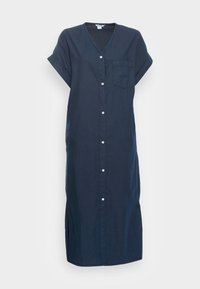 Vestido de algodão azul marinho com decote em V, mangas curtas, fecho de botão frontal e fendas laterais. Apresenta um pequeno bolso do lado esquerdo.