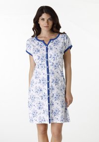 Abito a maniche corte in tessuto bianco con motivo floreale blu, bordatura blu attorno al colletto e alle maniche, e chiusura con bottoni sul davanti.