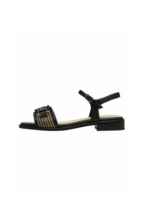 Sandale en cuir noir avec une partie tissée au centre, une sangle de cheville avec boucle, un petit talon carré, une semelle intérieure lisse et un design minimaliste.