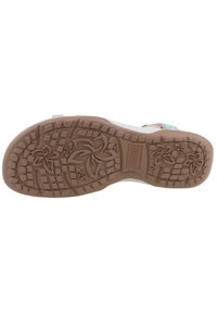 Semelle de chaussure avec un motif floral et en grille, fabriquée en caoutchouc de couleur brun clair, dotée de crampons surélevés pour l'adhérence et le soutien.