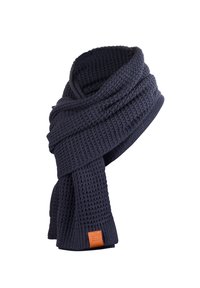 Navy knitted scarf with a waffle texture, featuring a leather tag on one end. Thick fabric provides warmth and comfort.