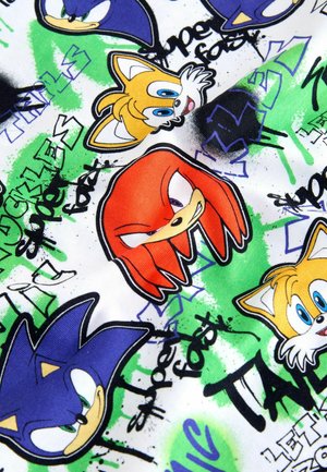 Kokvilnas audums ar krāsainiem multfilmu varoņu sejiņām, kas ir dzīvīgi un krāšņi izstrādāti. Fons ietver zaļu un melnu graffiti stila tekstu un rakstus.