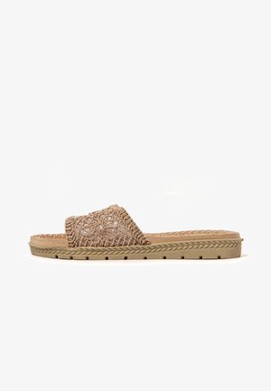 Slide sandal with a woven tan upper featuring floral embroidery, a textured footbed, and a flexible rubber sole with a braided edge.