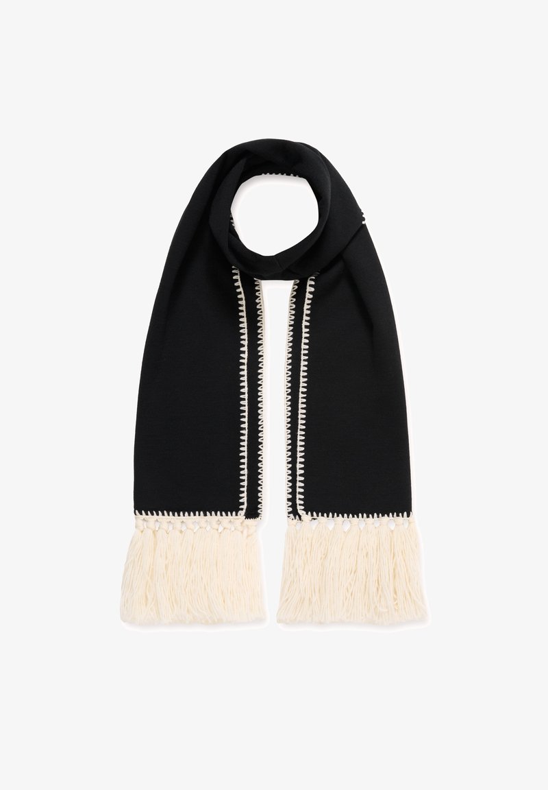 Sorte tørklæde med hvide frynser i enderne. Har kontrasterende hvid syning og en glat tekstur, designet i en lang, smal form.