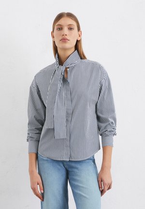 Striped button-up shirt in navy and white. Features a high collar with a tie detail, long sleeves, and a relaxed fit. Smooth cotton fabric.