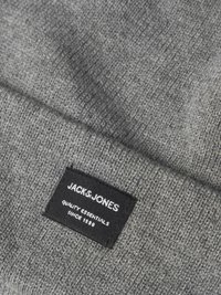 Gray knitted fabric hat with a textured finish. Features a black label reading "JACKS & JONES," with white text and a simple design.