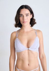 Light lavender lace lingerie set featuring a triangle bralette with scalloped edges, adjustable straps, and a hook closure at the front.