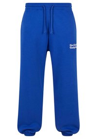 Blå bomullssweatpants med snor i midjen og elastiske ankler. Har hvit tekstdesign som leser "New York Basketball."