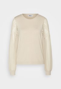 Beżowy sweter z okrągłym dekoltem, prążkowanym body i przezroczystymi, wzorzystymi, bufkami rękawów. Miękka tekstura z dopasowanymi mankietami. Widoczna metka marki "ONLY".